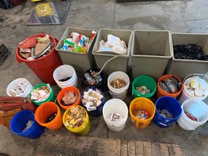 Several buckets and bins full of materials gathered together