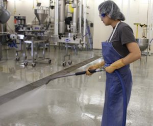 cleaning floor in food manufacturing plant